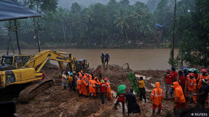 Rescue workers carry the body of a victim in the Idukkio district in Kerala, India, on Sunday