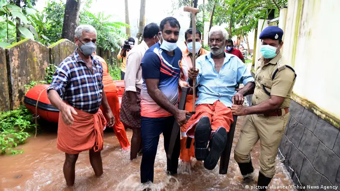 Rescuers transfer an old man in Alappuzha district of Kerala state