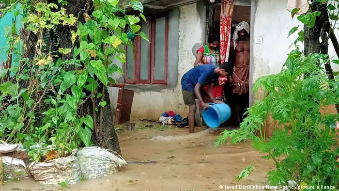 A man removes water from his house as heavy rain lashes in Thiruvananthapuram