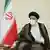  Ebrahim Raisi with face mask sitting next to Iranian flag