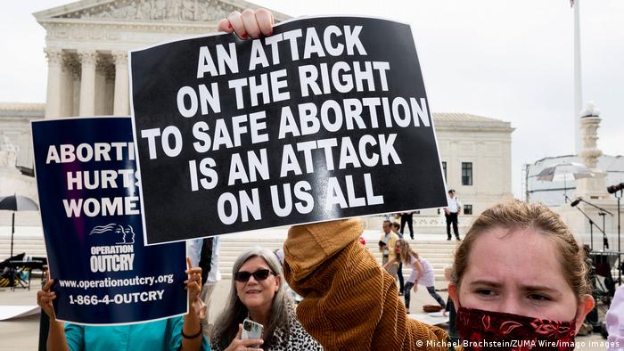 Protesters hold signs at an abortion rights demonstration in Washington on October 4, 2021