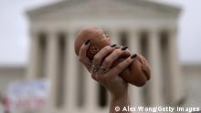 WASHINGTON, DC - OCTOBER 12: A pro-life activist holds up a baby doll during a rally for a ban on abortion in front of the U.S. Supreme Court October 12, 2021 in Washington, DC. The Supreme Court is scheduled to hear oral arguments today in Cameron v. EMW Women’s Surgical Center, a case revolving around Kentucky Attorney General Daniel Cameron’s attempt to intervene in a legal challenge to an abortion ban of a surgical procedure commonly used in the second trimester of pregnancy, after two courts had already ruled it was unconstitutional. If Cameron is successful, it will open the door for him to attempt to revive this ban. (Photo by Alex Wong/Getty Images)