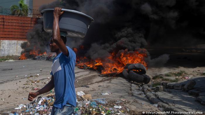  Burning tires block a road, set by protesters in Port-au-Prince