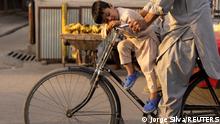 A boy sleeps as he rides a bicycle in Kabul, Afghanistan October 18, 2021. REUTERS/Jorge Silva TPX IMAGES OF THE DAY