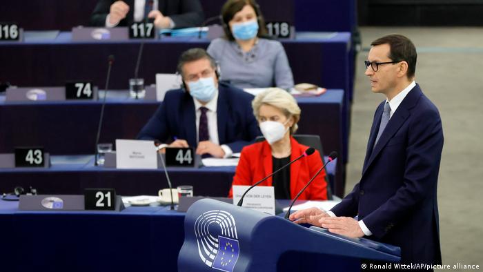 Polish Prime Minister Mateusz Morawiecki speaking at the European Parliament, sat behind him is European Commission President Ursula von der Leyen