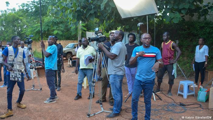 Burkina Faso |  FESPACO, several men outside, some with cameras 