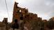 Two boys in Yemen look at a building destroyed by the fighting Two boys in Yemen look at a building destroyed by the fighting