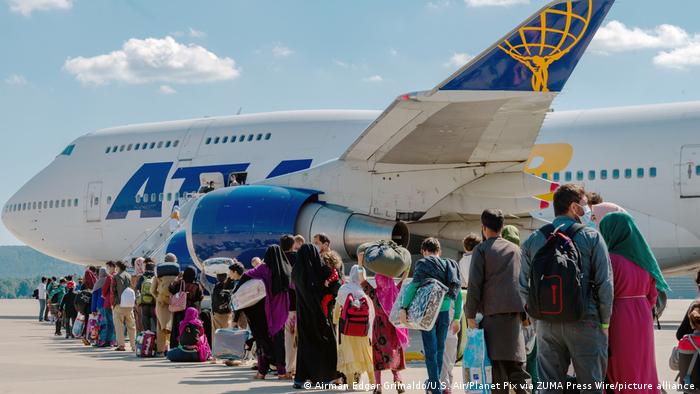 Afghan refugees evacuated from Kabul board a flight from Ramstein Air Base