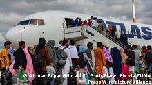 STYLELOCATIONAfghan refugees board a Atlas Air commercial aircraft for transfer to the United States after evacuation from Kabul at Ramstein Air Base August 24, 2021 in Ramstein-Miesenbach, Germany. The Pentagon called up 18 civilian aircraft from United Airlines, American Airlines, Delta Air, Atlas Air and Hawaiian airlines under the Civil Reserve Air Fleet law to assist in transferring evacuees as part of Operation Allies Refuge. (Credit Image: Â© Airman Edgar Grimaldo/U.S. Air/Planet Pix via ZUMA Press Wire