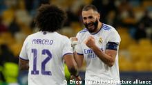 Real Madrid's Karim Benzema, right, celebrates after scoring his side's fifth goal during the Champions League group D soccer match between Shakhtar Donetsk and Real Madrid at the Olympiyskiy stadium in Kyiv, Ukraine, Tuesday, Oct. 19, 2021. (AP Photo/Efrem Lukatsky)