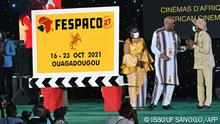 President Roch Marc Christian Kabore of Burkina Faso (2ndR) chats with Senegalese Minister of Culture Abdoulaye Diop (R) and Burkina Faso Ministre of Culture, Arts and Turism Elise Ilboudo Thiombiano (C) during the 27th Pan-African Film and Television Festival (FESPACO) opening ceremony on October 16, 2021 at the palais des sports in Ouagadougou (Photo by Issouf SANOGO / AFP)