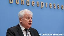 Germany's Interior Minister Horst Seehofer attends a press conference on migration, in Berlin, on October 20, 2021. (Photo by CHRISTIAN MANG / POOL / AFP)
