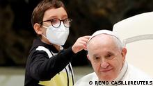 10-year-old boy Paolo Junior approaches Pope Francis during the weekly general audience at the Vatican, October 20, 2021. REUTERS/Remo Casilli TPX IMAGES OF THE DAY