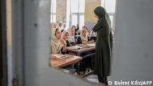 Afghan girls attend a class in a school in Kandahar on September 26, 2021. (Photo by BULENT KILIC / AFP)