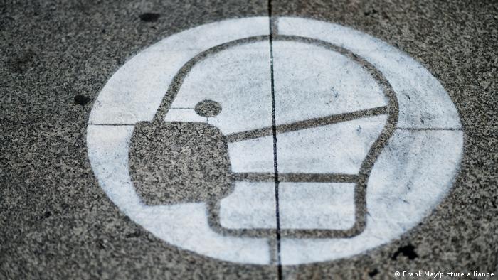 Symbol for face mask painted onto German street to remind people to wear them