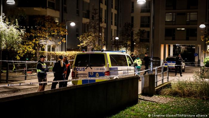 Ambulance and police stand at the scene where Swedish rapper Einar was shot to death