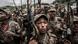  Ethiopian National Defence Forces (ENDF) soldiers brandish weapons as they shout slogans.