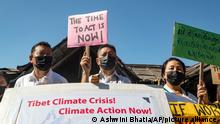 Exile Tibetans participate in a street protest to highlight environmental issues in Tibet ahead of the COP26 summit, in Dharmsala, India, Friday, Oct. 22, 2021. (AP Photo/Ashwini Bhatia)