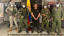 In this photo released by the Colombian presidential press office, one of the country’s most wanted drug traffickers, Dairo Antonio Usuga, alias “Otoniel,” leader of the violent Clan del Golfo cartel, is presented to the media at a military base in Necocli, Colombia, Saturday, Oct. 23, 2021. (Colombian presidential press office via AP)