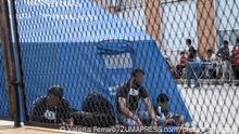May 31, 2021, Roccella Jonica, Calabria, Italy: Men seen socializing in front of a shelter..Nearly 230 migrants, floating towards Italy, have been rescued by the Italian coast guard and carried in the port town of Roccella Jonica, southern region of Calabria. Women, children and men of different nationalities have been taken to the local first aid centre for assistance and identification. (Credit Image: © Valeria Ferraro/SOPA Images via ZUMA Wire