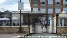 May 31, 2021, Roccella Jonica, Calabria, Italy: Exterior view of the first aid centre in Roccella with people in the courtyard..Nearly 230 migrants, floating towards Italy, have been rescued by the Italian coast guard and taken to the port town of Roccella Jonica in the southern region of Calabria. Women, children and men of different nationalities have been taken to the local first aid centre for assistance and identification. (Credit Image: © Valeria Ferraro/SOPA Images via ZUMA Wire