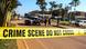 Cordoned off road which reads "Crime scene do not cross" Cordoned off road which reads "Crime scene do not cross"