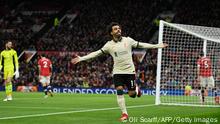 Liverpool's Egyptian midfielder Mohamed Salah celebrates after scoring their fifth goal, his third during the English Premier League football match between Manchester United and Liverpool at Old Trafford in Manchester, north west England, on October 24, 2021. - RESTRICTED TO EDITORIAL USE. No use with unauthorized audio, video, data, fixture lists, club/league logos or 'live' services. Online in-match use limited to 120 images. An additional 40 images may be used in extra time. No video emulation. Social media in-match use limited to 120 images. An additional 40 images may be used in extra time. No use in betting publications, games or single club/league/player publications. (Photo by Oli SCARFF / AFP) / RESTRICTED TO EDITORIAL USE. No use with unauthorized audio, video, data, fixture lists, club/league logos or 'live' services. Online in-match use limited to 120 images. An additional 40 images may be used in extra time. No video emulation. Social media in-match use limited to 120 images. An additional 40 images may be used in extra time. No use in betting publications, games or single club/league/player publications. / RESTRICTED TO EDITORIAL USE. No use with unauthorized audio, video, data, fixture lists, club/league logos or 'live' services. Online in-match use limited to 120 images. An additional 40 images may be used in extra time. No video emulation. Social media in-match use limited to 120 images. An additional 40 images may be used in extra time. No use in betting publications, games or single club/league/player publications. (Photo by OLI SCARFF/AFP via Getty Images)