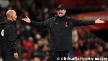 Liverpool's German manager Jurgen Klopp (R) gestures to fourth official Mike Dean during the English Premier League football match between Manchester United and Liverpool at Old Trafford in Manchester, north west England, on October 24, 2021. - RESTRICTED TO EDITORIAL USE. No use with unauthorized audio, video, data, fixture lists, club/league logos or 'live' services. Online in-match use limited to 120 images. An additional 40 images may be used in extra time. No video emulation. Social media in-match use limited to 120 images. An additional 40 images may be used in extra time. No use in betting publications, games or single club/league/player publications. (Photo by Oli SCARFF / AFP) / RESTRICTED TO EDITORIAL USE. No use with unauthorized audio, video, data, fixture lists, club/league logos or 'live' services. Online in-match use limited to 120 images. An additional 40 images may be used in extra time. No video emulation. Social media in-match use limited to 120 images. An additional 40 images may be used in extra time. No use in betting publications, games or single club/league/player publications. / RESTRICTED TO EDITORIAL USE. No use with unauthorized audio, video, data, fixture lists, club/league logos or 'live' services. Online in-match use limited to 120 images. An additional 40 images may be used in extra time. No video emulation. Social media in-match use limited to 120 images. An additional 40 images may be used in extra time. No use in betting publications, games or single club/league/player publications. (Photo by OLI SCARFF/AFP via Getty Images)