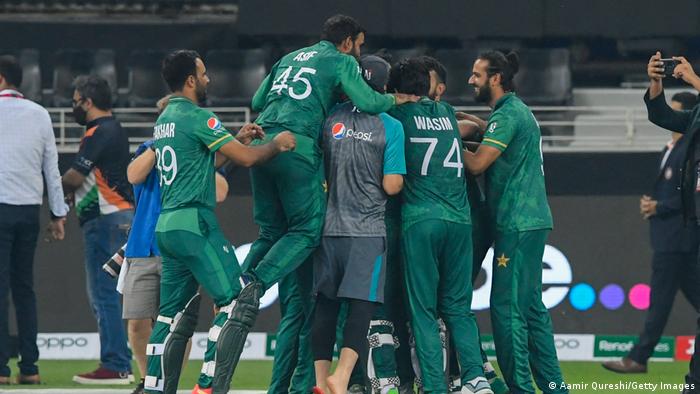 Pakistan's team members celebrate their victory at the end of the ICC mens Twenty20 World Cup cricket match between India and Pakistan at the Dubai International Cricket Stadium in Dubai