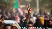 Pro-democracy protesters flash the victory sign as they take to the streets to condemn a takeover by military officials, in Khartoum, Sudan, Monday Oct. 25, 2021. Sudan’s military seized power Monday, dissolving the transitional government hours after troops arrested the acting prime minister and other officials. The takeover comes more than two years after protesters forced the ouster of longtime autocrat Omar al-Bashir and just weeks before the military was expected to hand the leadership of the council that runs the African country over to civilians. (AP Photo/Ashraf Idris)