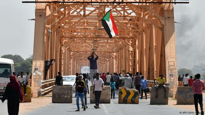 Sudanese people protest against a military coup overthrowing the transition to civilian rule on October 25, 2021 in the capital Khartoum's twin city of Omdurman
