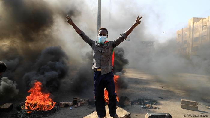 Sudanese protesters burn tires to block a road in the Sudanese capital of Khartoum