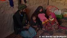 This picture taken on October 14, 2021 shows children Farishteh (R) and Shokriya (2R), which were recently sold to the families of their future husbands, sitting with their parents inside a tent at the Shamal Darya Internally Displaced People (IDP) camp in Qala-i-Naw, Badghis Province. Child marriage has been practised in Afghanistan for centuries, but war and climate change-related poverty have driven many families to resort to striking deals earlier and earlier in girls' lives.
Hoshang Hashimi / AFP
