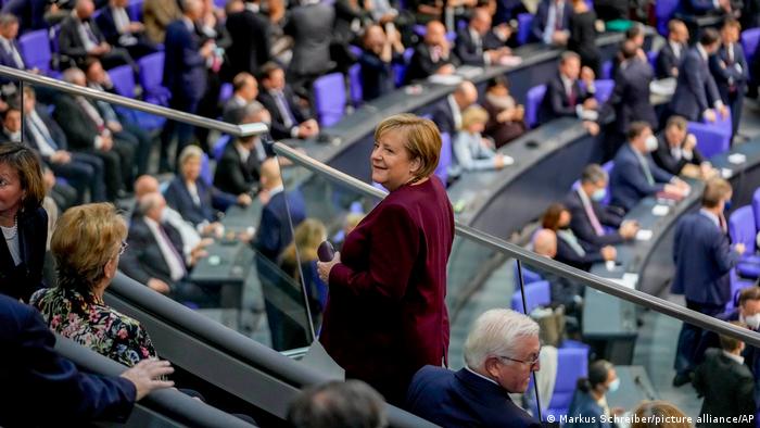 Angela Merkel smiling in a packed Bundestag