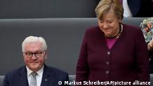 German Chancellor Angela Merkel stands next to German President Frank-Walter Steinmeier during the first plenary session of the German parliament Bundestag after the elections, Berlin, Tuesday, Oct. 26, 2021. (Photo/Markus Schreiber)