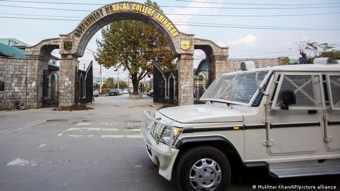 A paramilitary vehicle passes the front gate of Government Medical College in Srinagar, Indian controlled Kashmir