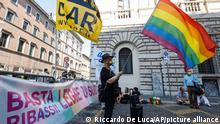 LGBT activists attend a protest near the Senate, asking for the approval of a law promoted by Democratic Party's lawmaker Alessandro Zan, aimed to extend further protections from discrimination to the LGBT community, in Rome, Tuesday, July 20, 2021. The banner at right reads 'Stop rebates! Law Zan now!' (AP Photo/Riccardo De Luca)