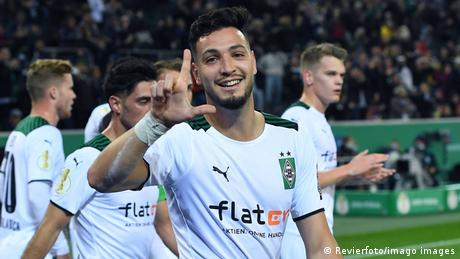 Ramy Bensebaini celebrates scoring a goal
