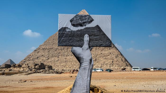 An installation entitled seen facing the pyramids on the Giza Plateau, near Cairo, Egypt on October 25, 2021
