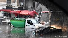 This photo taken on October 26, 2021 and obtained from Italian news agency Ansa on October 27, 2021 sows a car and a garbage truck submerged under the arches of the Marina, near Catania's fish market, in Catania, Sicily, after heavy rain hit the city and the province. (Photo by STRINGER / ANSA / AFP) / Italy OUT