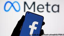 A smartphone with Facebook's logo is seen in front of displayed Facebook's new rebrand logo Meta in this illustration taken October 28, 2021. REUTERS/Dado Ruvic/Illustration