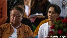 Myanmar's State Counselor Aung San Suu Kyi (R) and Win Htein, chief executive committee members of the National League for Democracy (NLD), attend the funeral service for the party's former chairman Aung Shwe in Yangon on August 17, 2017. / AFP PHOTO (Photo credit should read /AFP via Getty Images)