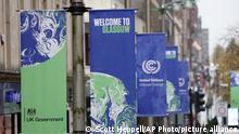 Banners are displayed in central Glasgow, Scotland, Friday, Oct. 29, 2021. The U.N. climate conference COP26 starts Sunday in Glasgow. (AP Photo/Scott Heppell)