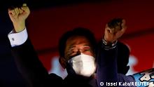 FILE PHOTO: Japan's Prime Minister Fumio Kishida, who is also the President of the ruling Liberal Democratic Party, raises his fist with the party's candidates atop the campaigning bus on the last day of campaigning for the October 31 lower house election, amid the coronavirus disease (COVID-19) pandemic, in Tokyo, Japan October 30, 2021. REUTERS/Issei Kato/File Photo