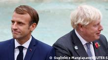 Britain's Prime Minister Boris Johnson and French President Emmanuel Macron look on in front of the Trevi Fountain during the G20 summit in Rome, Italy, October 31, 2021. REUTERS/Guglielmo Mangiapane TPX IMAGES OF THE DAY