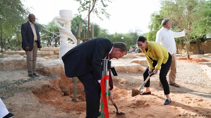 Dalia Samra-Rohte, the German delegate of the German Industry and the German ambassador to Saudi Arabia, Dieter Lamle, plant a tree