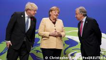 Britain's Prime Minister Boris Johnson and United Nations Secretary-General Antonio Guterres greet Germany's Chancellor Angela Merkel during arrivals at the UN Climate Change Conference (COP26) in Glasgow, Scotland, Britain, November 1, 2021. Christopher Furlong/Pool via REUTERS 