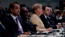 German Chancellor Angela Merkel listens during the opening ceremony of the COP26 U.N. Climate Summit, in Glasgow, Scotland, Monday, Nov. 1, 2021. The U.N. climate summit in Glasgow gathers leaders from around the world, in Scotland's biggest city, to lay out their vision for addressing the common challenge of global warming.(AP Photo/Alberto Pezzali)