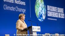 GLASGOW, SCOTLAND - NOVEMBER 01: In this handout photo provided by the German Government Press Office (BPA), German Chancellor Angela Merkel speaks during the UN Climate Change Conference COP26 at SECC on November 1, 2021 in Glasgow, United Kingdom. World Leaders attending COP26 are under pressure to agree measures to deliver on emission reduction targets that will lead the world to net-zero by 2050. Other goals of the summit are adapting to protect communities and natural habitats, mobilising $100billion in climate finance per year and get countries working together to meet the challenges of the climate crisis. (Photo by Guido Bergmann/Bundesregierung via Getty Images)