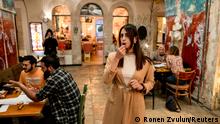 A woman blows a whistle during a language exchange program for Israelis and Palestinians modelled on speed dating, in Jerusalem, October 27, 2021. Picture taken October 27, 2021. REUTERS/Ronen Zvulun